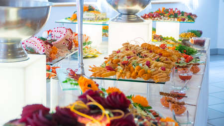 people group catering buffet food indoor in luxury restaurant with meat colorful fruits and vegetables.の写真素材