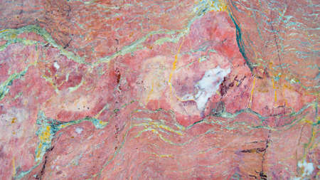 Background old red marble wall close-up.