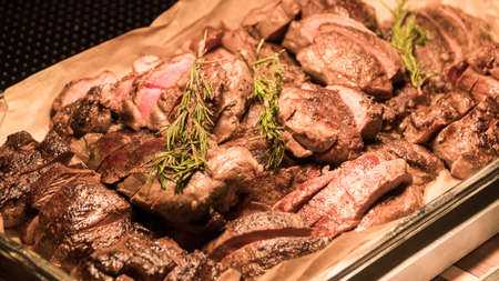 the buffet is the meat under the lamp.