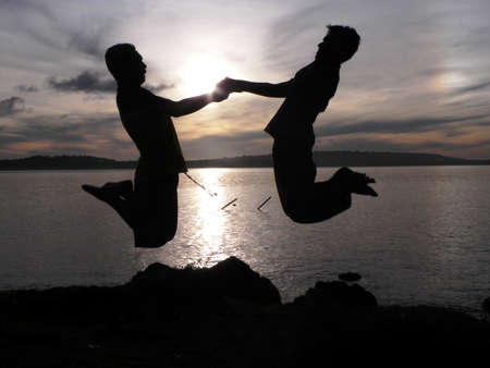 SILHOUETTE OF BOYS JUMPING の写真素材