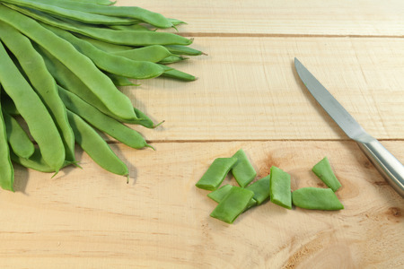Group of green beans on wooden background with space for text