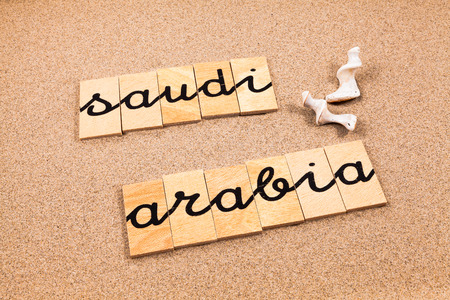 Words FORMED from small pieces of wood container containing a sun and beach tourist destination Saudi Arabiaの写真素材