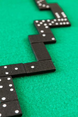Dominoes background. Image related to classic and online casino game dominoes on a green background from a player's perspectiveの写真素材