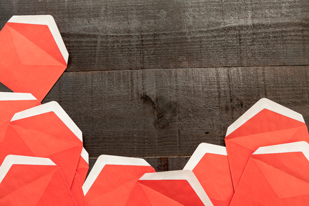 The image shows open red envelopes on wooden backgroundの写真素材