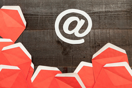 The image shows open red envelopes on wooden backgroundの写真素材