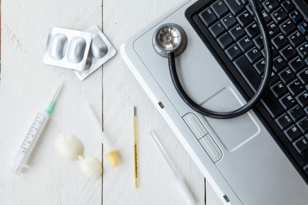 Portable medical and instrumental retro computer on white wooden backgroundの写真素材