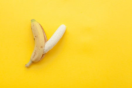 Peel banana and fruit on a yellow background and colorful backgroundの写真素材