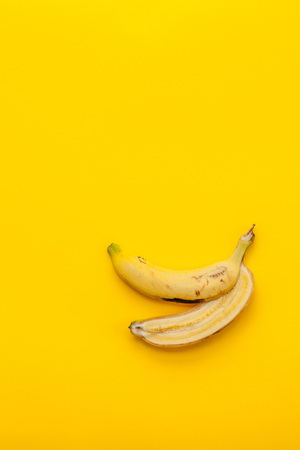 Peel banana and fruit on a yellow background and colorful backgroundの写真素材
