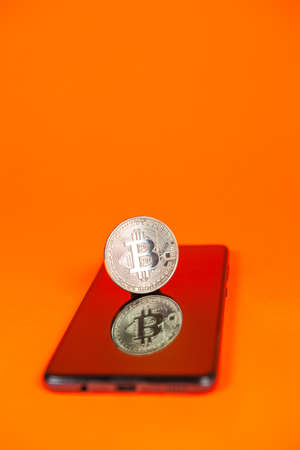 Photograph of bitcoin coins symbolizing the financial market of cryptocurrencies on a colored background and without peopleの写真素材