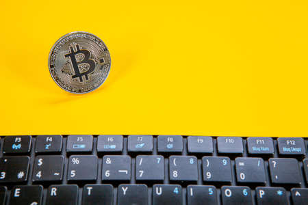 Photograph of bitcoin coins symbolizing the financial market of cryptocurrencies on a colored...