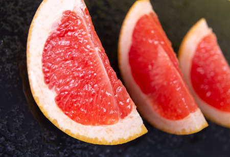 horizontal photo of fresh red grapefruit cut into pieces