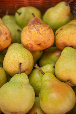 Ripe pears in a basket on the market. Close-upの写真素材