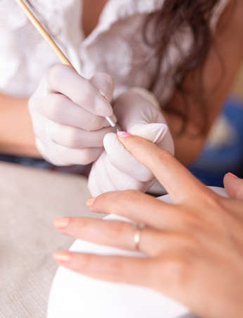Close-up of a female manicurist doing a manicureの写真素材