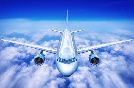 Airplane in the clouds of blue skyの写真素材