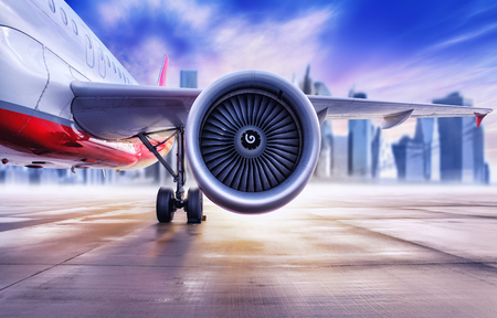 Airplane in front of a big city skylineの写真素材