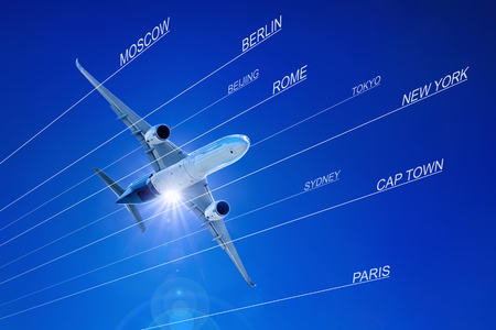 modern airliner against a blue sky with various destinationsの写真素材