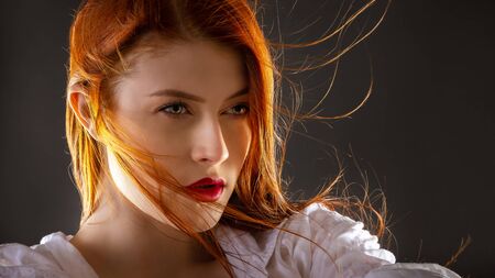 Beautiful young woman with long red hair