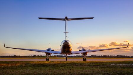 Modern jet against a sunsetの写真素材