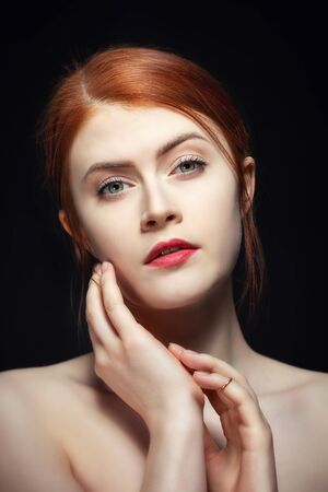 Portrait of a young beauty with long red hairの写真素材