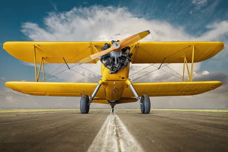 historical biplane on a runway ready for take offの写真素材