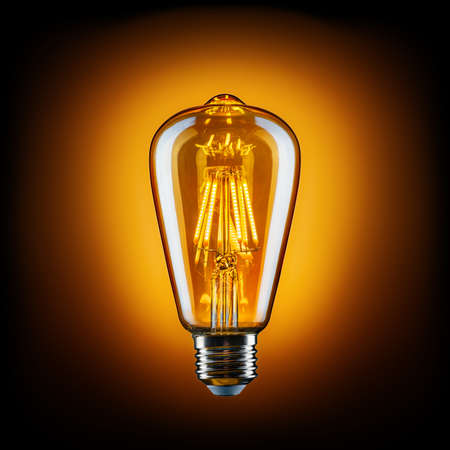 vintage LED light bulb against blackの写真素材