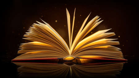 close up of an open book with glowing lightの写真素材