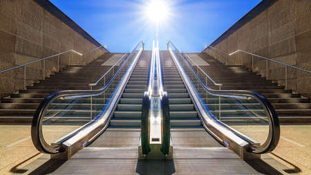 modern escalator against a sunny blue skyの写真素材