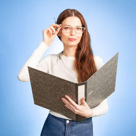 young secretary with a folder in her handの写真素材