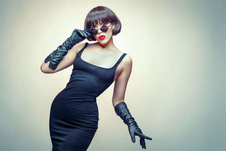 young beauty wearing gloves and sun glassesの写真素材