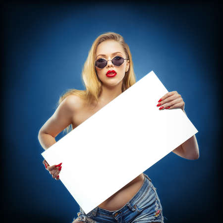 young beauty with a white board in her handsの写真素材