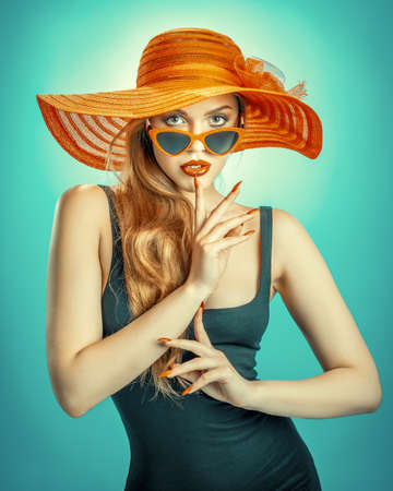 young beauty with a straw hat and sun glassesの写真素材
