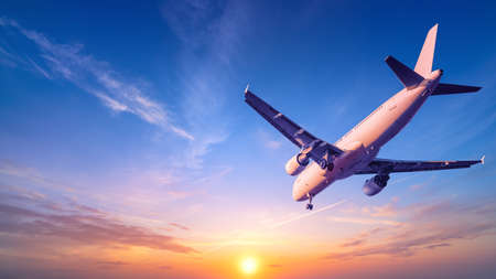 modern airliner against a sunsetの写真素材
