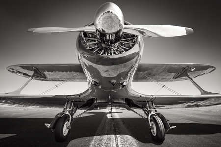 historical biplane on a runwayの写真素材