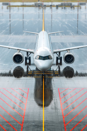 modern airliner arrives in the rainの写真素材