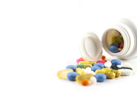 pharmaceutical medicine pills tablets and capsules with a open bottle on white backgroundの写真素材