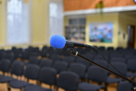 Microphone over the blurred business conference hall or seminar room, Blurred backgroundの写真素材