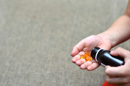 Small child taking medicineの写真素材