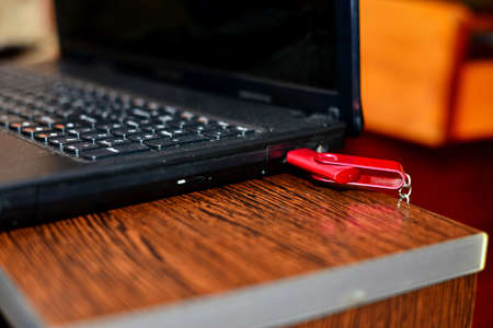Hand in black glove with red USB flash cards. Hacker copied files from a business computerの写真素材