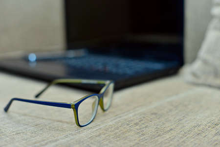 Eye Glasses on Businessman Wooden Table with Other Stuffs - Keyboard, Notebook,