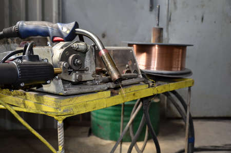 Close-up of a metal gas cylinder with a reducer and a pressure sensor in the background industrial...