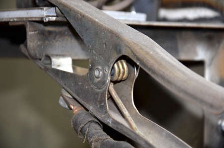 Close-up of a metal gas cylinder with a reducer and a pressure sensor in the background industrial workshop. Close up focus view of welding equipment. Acetylene gas cylinder tank with gauge regulators manometers in the industrial fabric workshop.の写真素材
