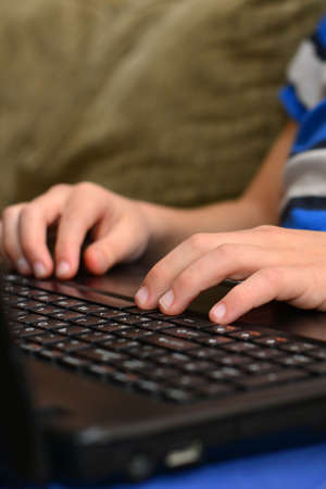 Smart Young Boy Works on a Laptop For His New Project in His Computer Science Class.の写真素材