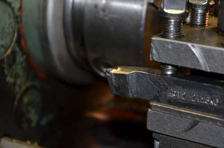 Professional machinist. Horizontal shot of a man operating lathe grinding machine metalworking...