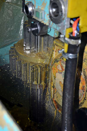 The abstract scene of CNC machining center with the bevel gear.Hi-precision machining process...