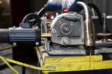 Close-up of a metal gas cylinder with a reducer and a pressure sensor in the background industrial...