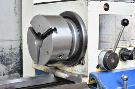 Professional machinist. Horizontal shot of a man operating lathe grinding machine metalworking...