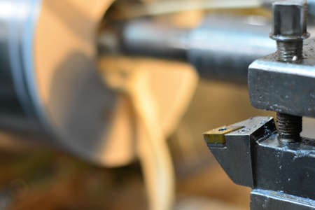 Professional machinist. Horizontal shot of a man operating lathe grinding machine metalworking industry concept copyspaceの写真素材