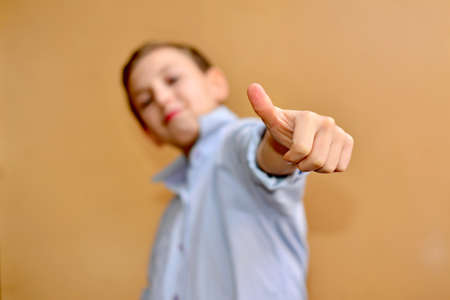 emotional boy with fashion haircut in light blue shirt in studioの写真素材