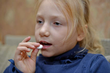 Small child taking medicine