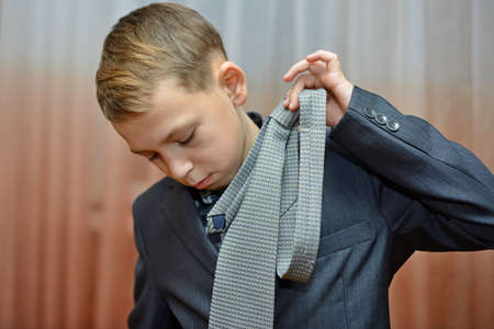 Cropped image of man in suit posing in a shop and holding measuring tape on his neckの写真素材